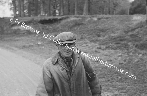 TRAMP WALKING ALONG ROAD